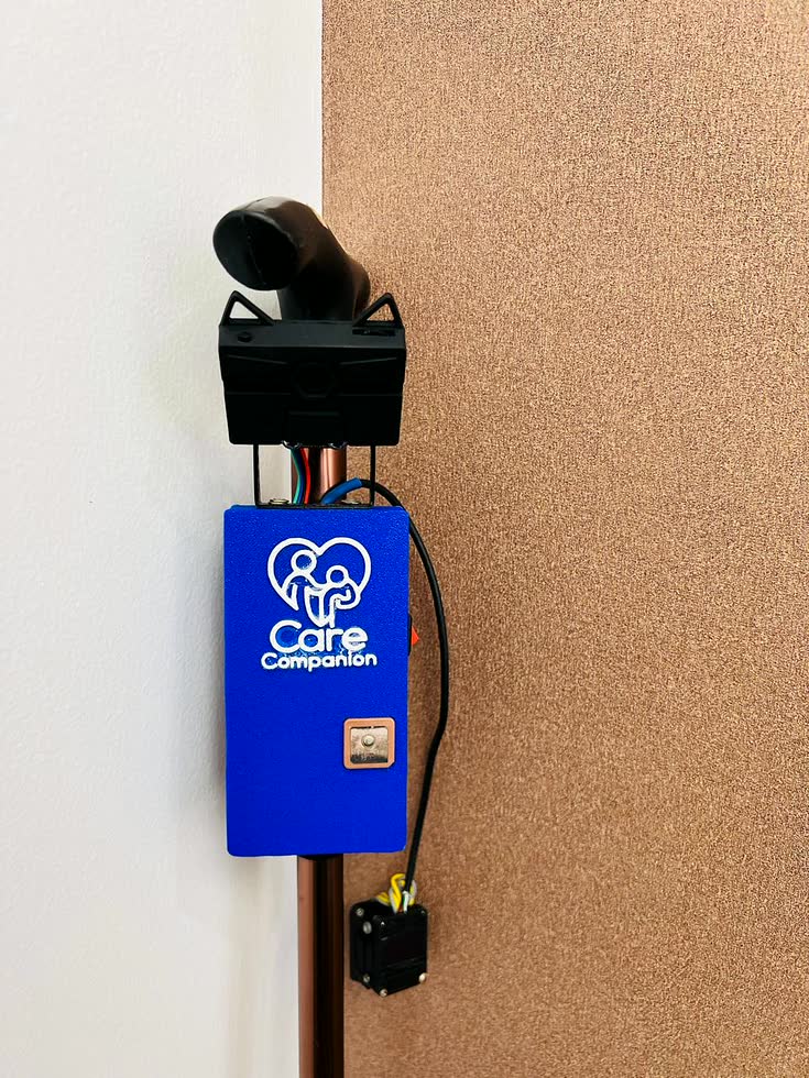 Close view of the mounted device: the HuskyLens camera on its bracket, its coloured wires running down into the blue enclosure, the GPS patch antenna set into the front face, and the display module below.